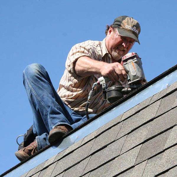 A man repairing the roof